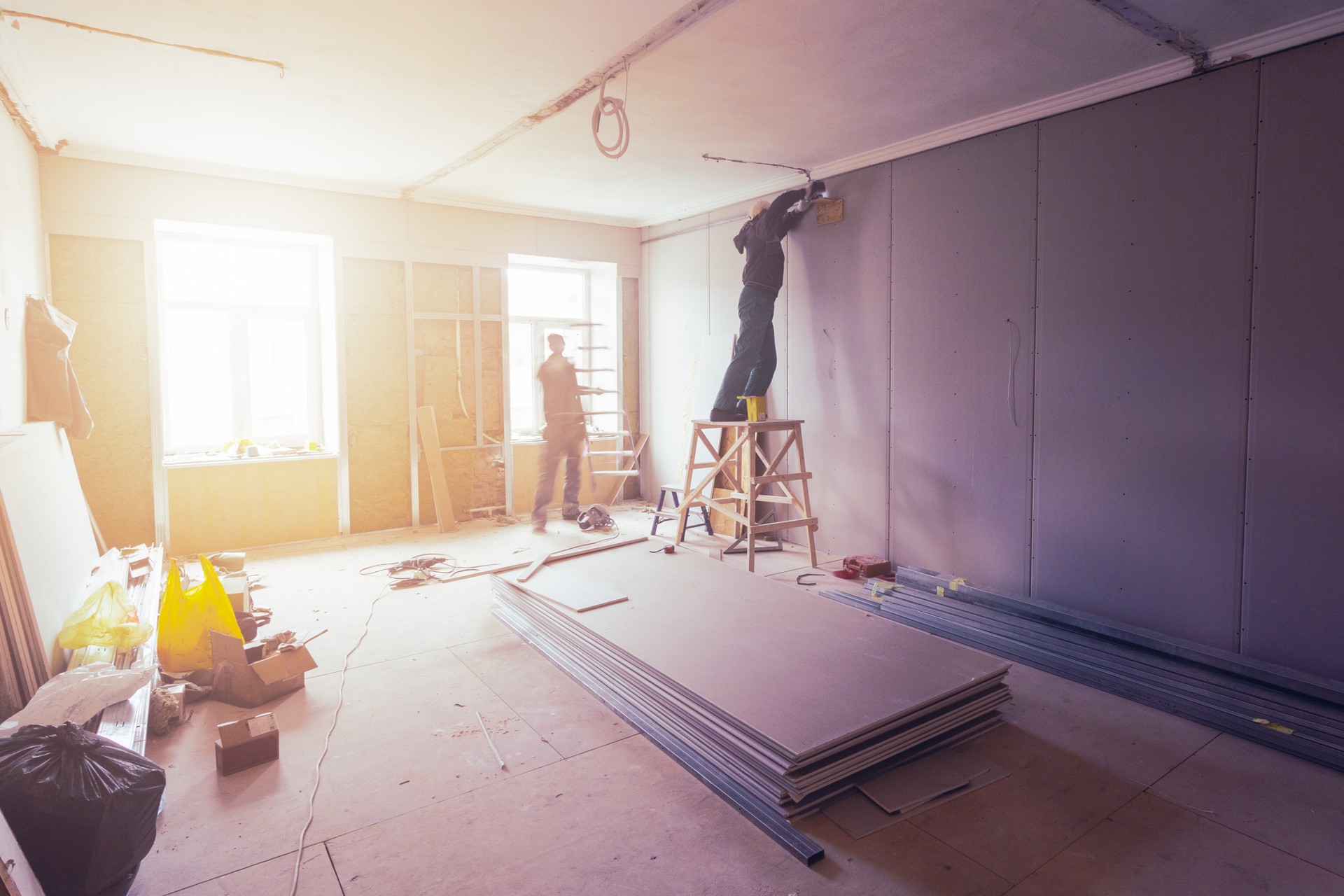 Workers are installing plasterboard (drywall) for gypsum walls in apartment is under construction, remodeling, renovation, extension, restoration and reconstruction.